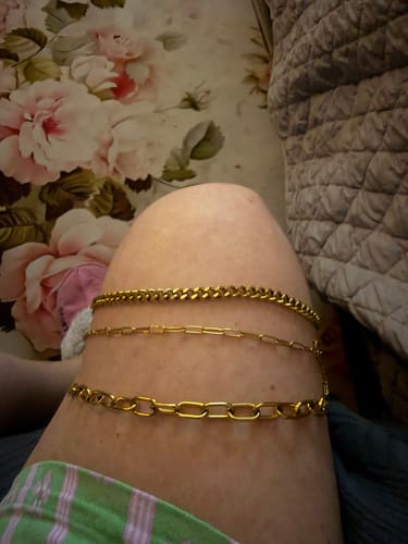 Customer's Maui Paperclip Bracelet stack worn on a person's leg.