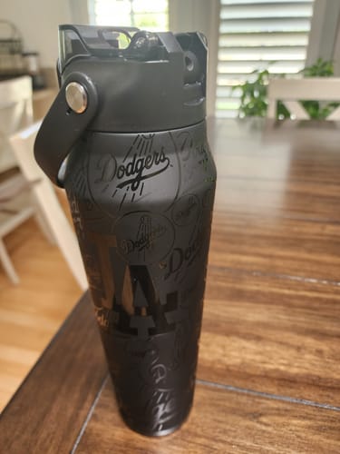 Customer's matte black Bottle Buddy 32oz Los Angeles Dodgers tumbler standing on a wooden table.