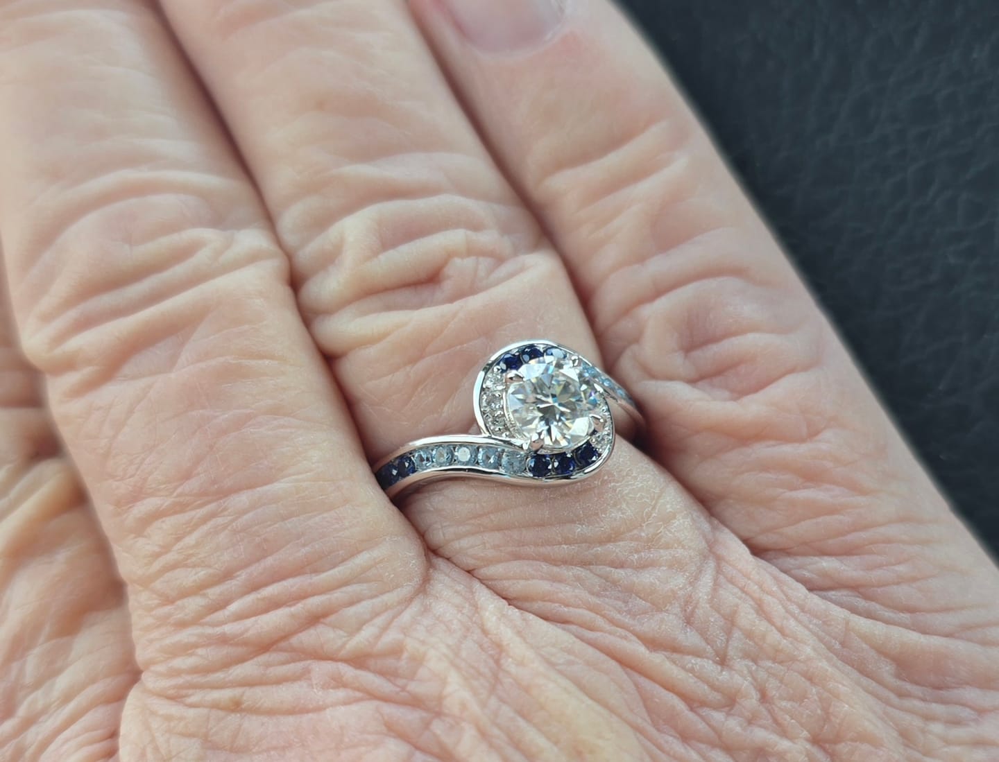 Customer photo review of Bypass Round Moissanite Gradient Ocean Blue Channel Set Engagement Ring