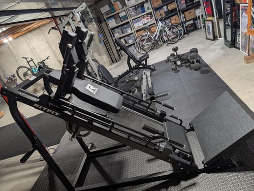 Customer's RitFit weight machine set up in a home gym with fitness equipment in the background.