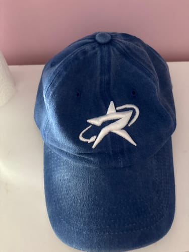 Customer's Radikal Merch acid wash mavi şapka, featuring a white star logo on the front.