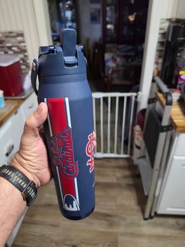Customer's navy blue Frost Buddy water bottle held in a hand, featuring a St. Louis Cardinals logo.