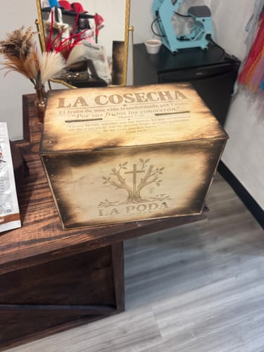 Customer's AtomStack A20 Pro V2 used to engrave La Cosecha text and a tree design onto a light-colored wooden box.