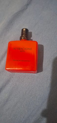 Customer's Attracione Men fragrance bottle with a bright orange square design.