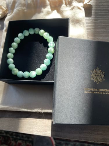 Customer's green Pierre de Lune bracelet in its open branded box.