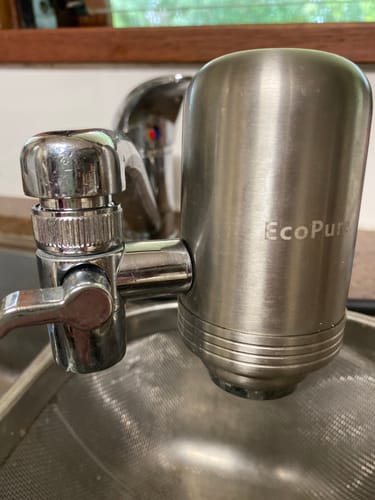 Customer's EcoPure silver water filter adapter attached to a metal kitchen faucet.