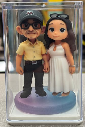 Customer's DoDoWish Custom Mini Me Figurine, a pair of chibi-style figures in a clear plastic display case.