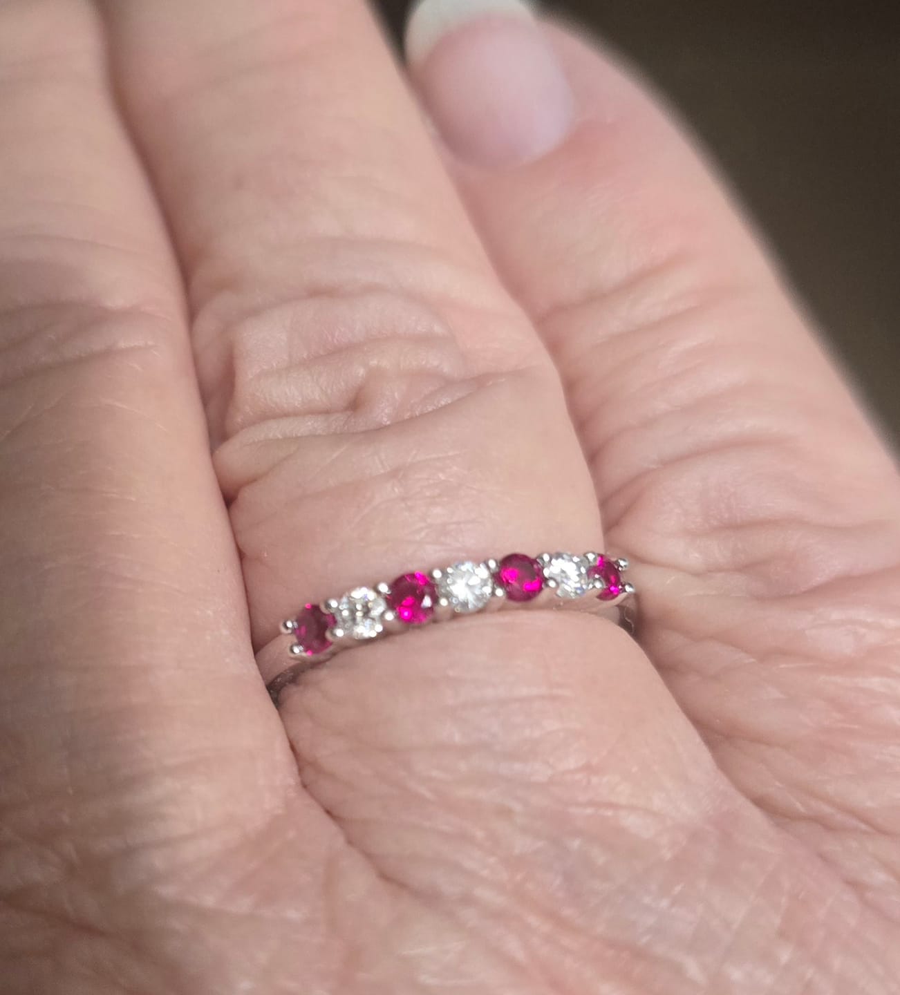 Customer photo review of Seven Stone Moissanite and Ruby Wedding Band Ring In Sterling Silver