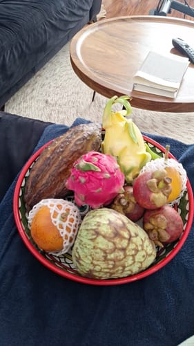 Reviewer's red Drachenfrucht in a bowl with various exotic fruits on a table.