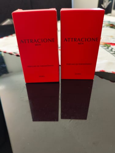 Customer's Attracione Men perfume boxes standing upright on a reflective dark surface.