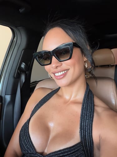 Customer's black Crochet Bustier Halter Top worn by a person inside a car, showing the textured knit and halter style.