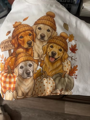 Customer's Custom Dog Photo Pumpkin Patch shirt, featuring a colorful print of four golden retrievers in knit hats.
