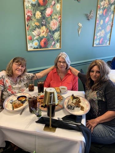 Reviewer's dining table with three friends, celebrating a 73rd birthday with drinks and meals.