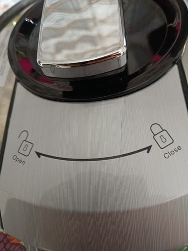 Customer's Novio SteelCook multicooker lid showing a thin visible crack running across the silver surface.