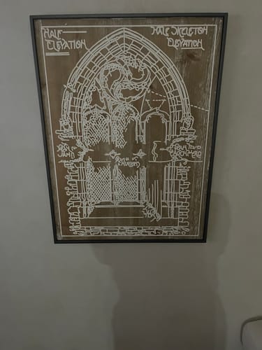 Customer's Darius French Provincial wall art, featuring a Gothic window print mounted on a wall.