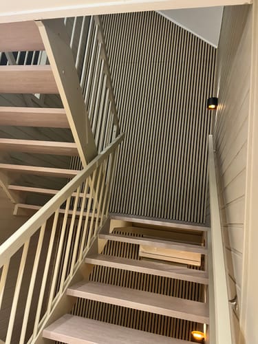 Reviewer's renovated staircase showing Santana Eik Kalk kontaktplast applied to stairs in a modern hallway.