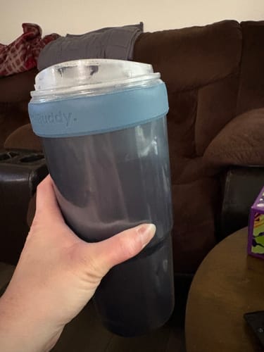 Customer's hand holding the Opal Sky To-Go Buddy cup insulator.