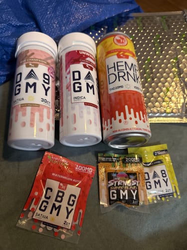 Customer's Delta 9 Gummies jars and various cannabis products arranged on a surface.