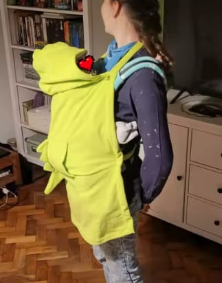 Customer photo review of DracoWrap™ | Manta-portabebés a prueba de viento con capucha de dinosaurio
