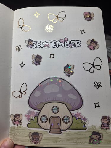 Customer's journal page decorated with Ultimate Subscription stickers, including a fairy house and fairy illustrations.