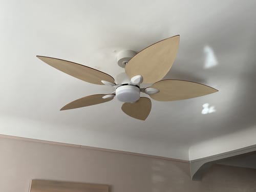 Customer's Virevole ceiling fan with light wood petals mounted on a white ceiling