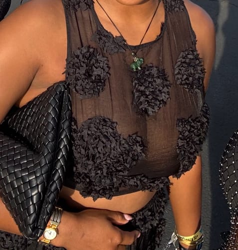 Customer's black Floral Appliqué Lace Crop Top close-up, showing floral details and a sheer mesh fabric.
