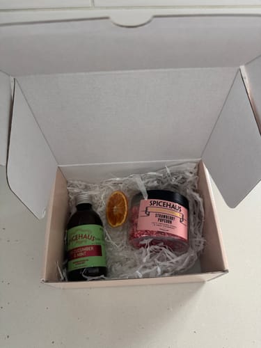 Customer's packaging for FERRERO ROCHER with a cocktail bottle and jar inside a white gift box