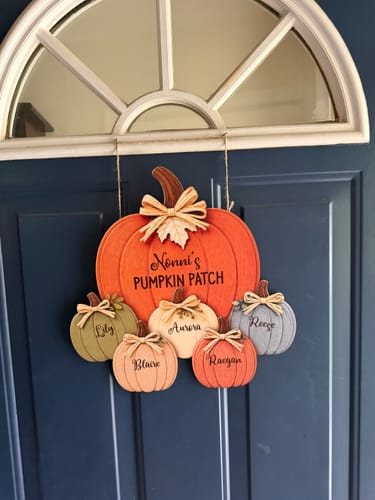 Customer's personalized Pumpkin Patch door hanger, featuring five small colored pumpkins with grandchildren's names.