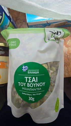 Customer's 30g bag of Organic Mountain Tea with white and green packaging, sitting on a table.