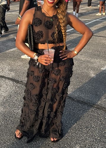 Customer's black Floral Appliqué Lace Crop Top worn with matching wideleg pants, standing outdoors.