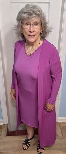 Reviewer wearing a magenta Brigitte Brianna Day to Day Pocket Dress paired with a matching long shrug.