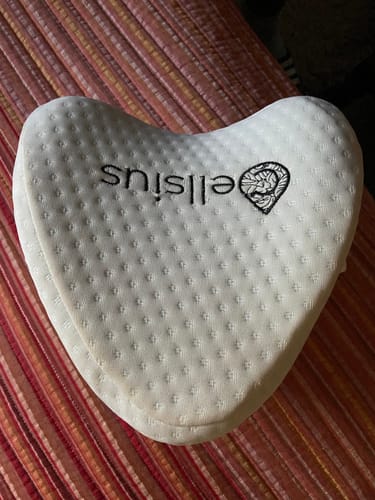 Customer's off-white, heart-shaped Cellsius orthopedic knee pillow with a textured cover.
