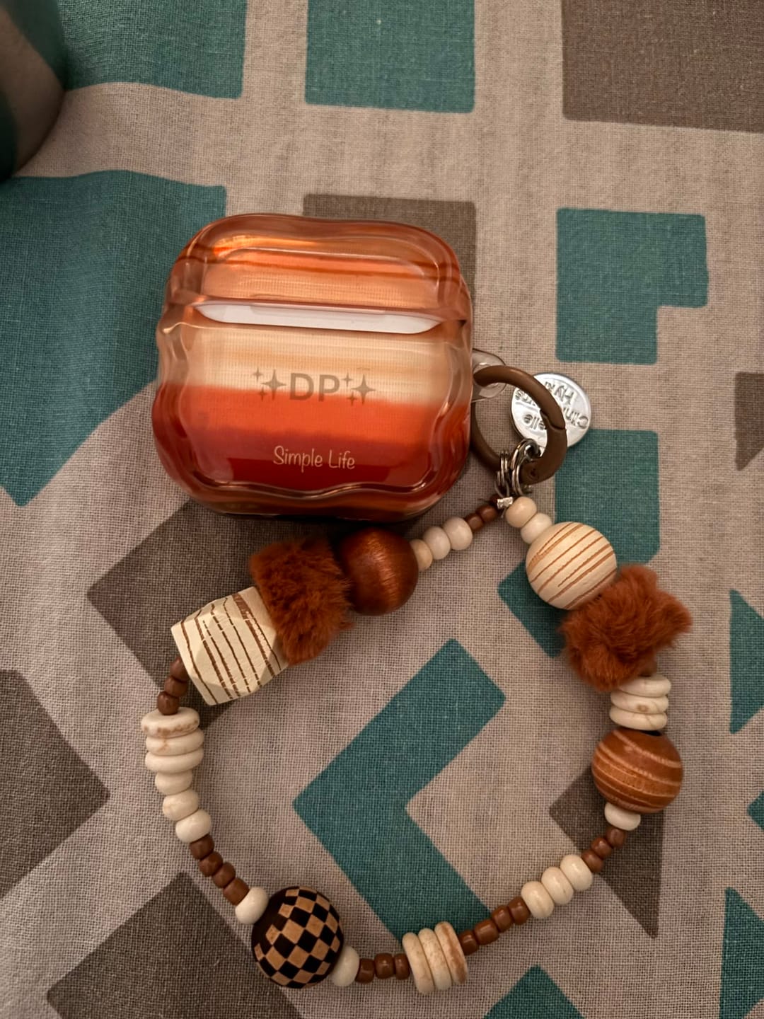 Customer photo review of Sand Orange Subtle Shades Airpod Pre-Order Case With Lanyard