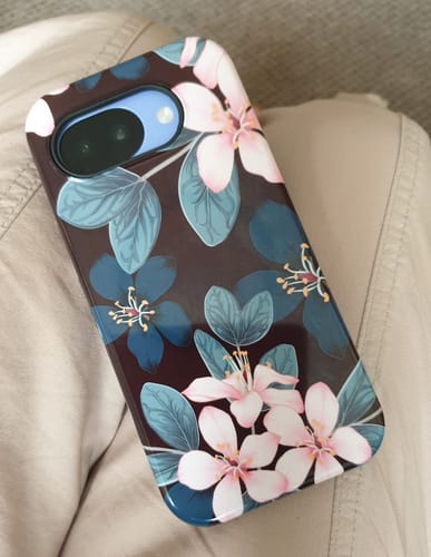 Customer's flower print phone case on a phone, showing the camera cutout and floral design.