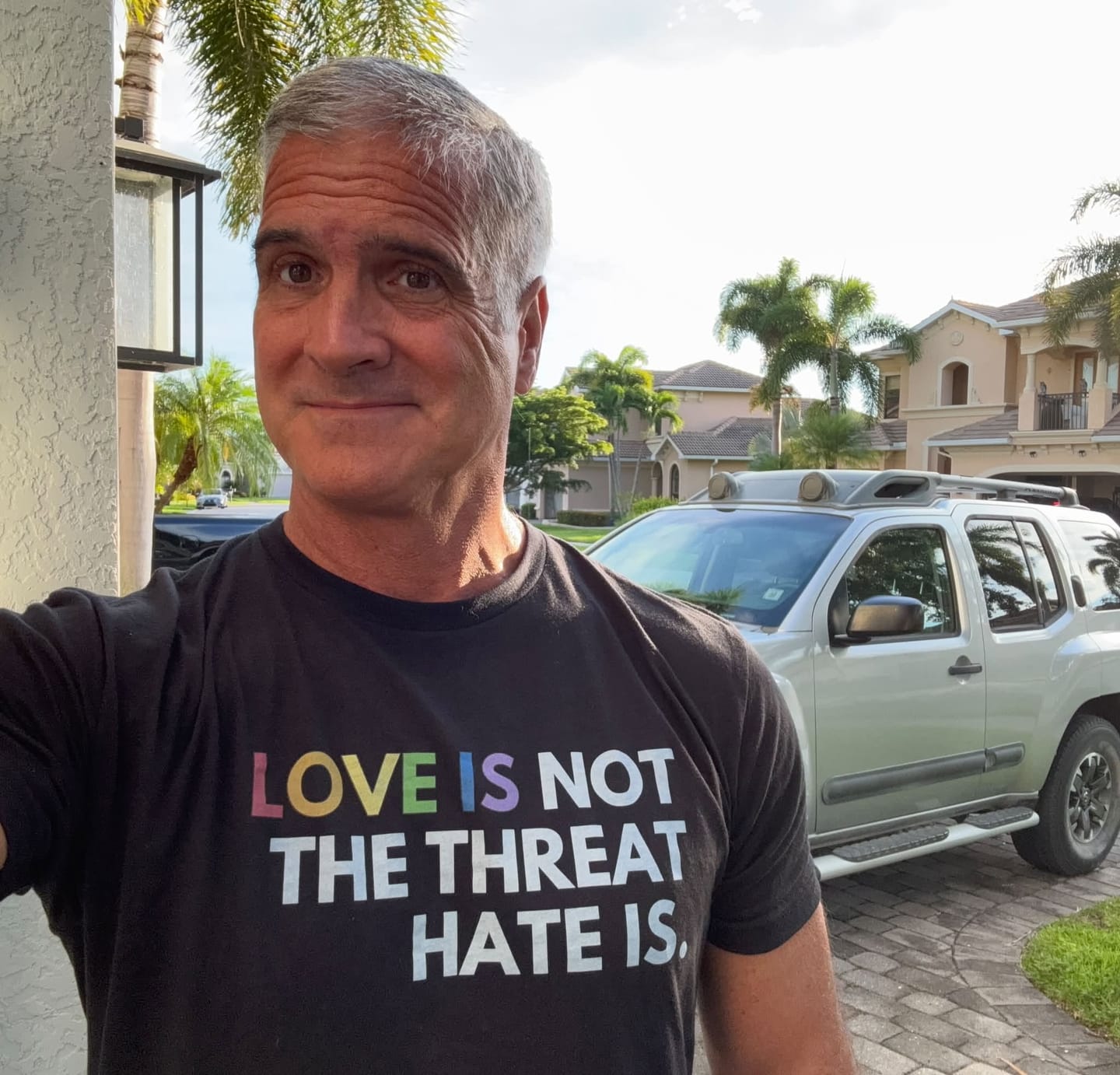 Customer photo review of Love is Not the Threat Pride Remix Unisex T-Shirt