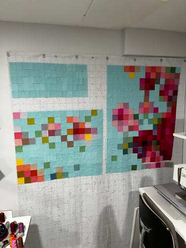 Customer's Tilda Embroidery Flower Vase quilt pieces laid out on a design wall, showing a grid of colorful squares.
