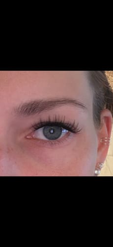 Customer's First Love lashes applied to one eye, showing a natural, soft doll-eye look.