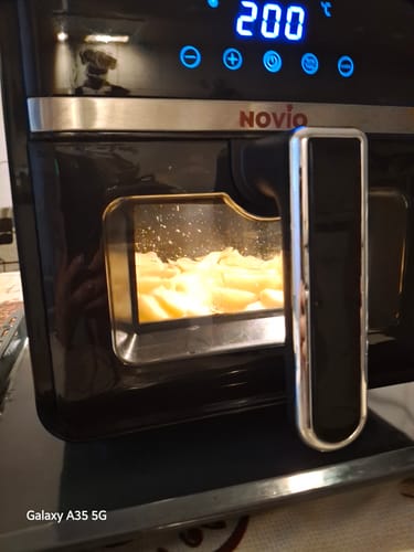 Customer's Novio StonePro air fryer in black, displaying a 200 degree temperature on its digital screen while cooking.