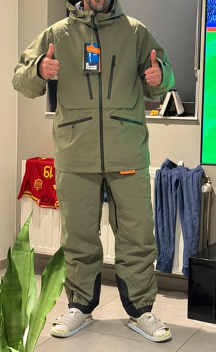 Customer's army green snow jacket and matching pants with a hooded, waterproof design, being worn for a fit check.