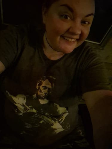 Customer's Lincoln Guitar T-Shirt, a grey short-sleeve shirt featuring a graphic of Abraham Lincoln playing a guitar.