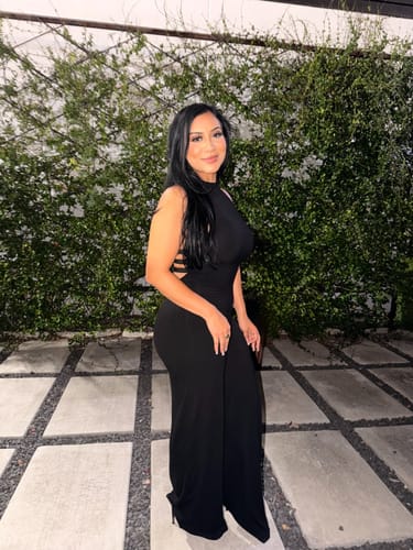 Customer's Butter Buckle Wide-Leg Jumpsuit, black and sleeveless, worn by a person outdoors at night.
