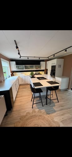 Reviewer's kitchen showing the installed black fiskebein wall tiles as a contrast against light cabinets.