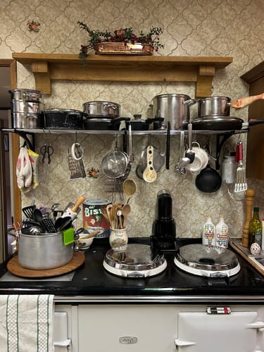 Customer's solid oak mantel shelf with corbels mounted above a kitchen stove, holding a copper planter.