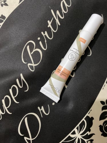 Customer's tube of Advance Lip Pigmentation Cream resting on a dark surface.