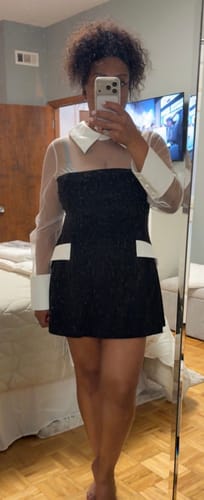 Customer's mirror selfie wearing the black and white Ponte Shirting Mini Dress with sheer sleeves.