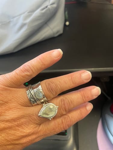 Customer's Aquamarine Leaf Spinner Ring and a teardrop ring on their finger