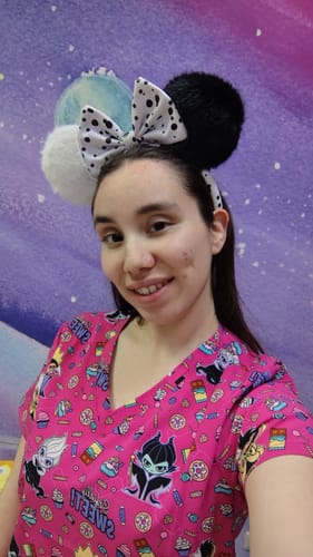 Reviewer wearing a Cherokee Disney TF796 scrub top with a pink background and Mickey Mouse ear headband