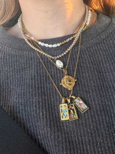 Customer's Golden Fortune Necklace layered with other necklaces, worn around the neck.