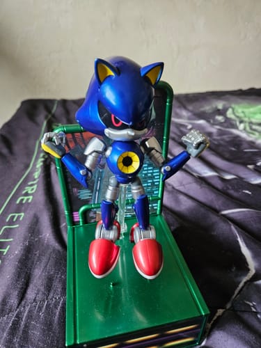 Customer's Modern Metal Sonic figure standing on a green display base in a posed position.