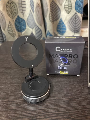 Customer's Casence 360 MagPro Magnetic Phone Holder standing next to its product box on a dark desk surface.